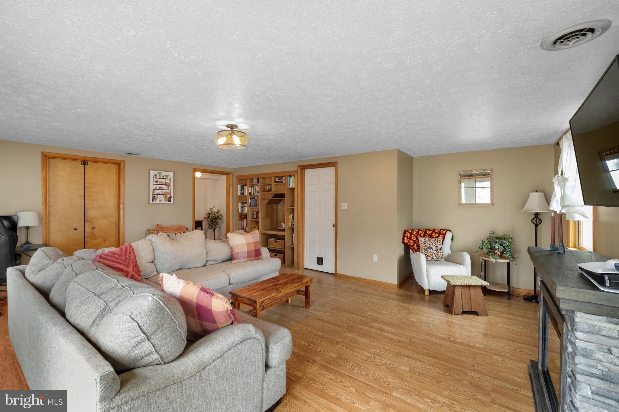 3360 Senedo Road Quicksburg, VA 22847 - Photo 29 of 58 a living room with furniture and a wooden floor
