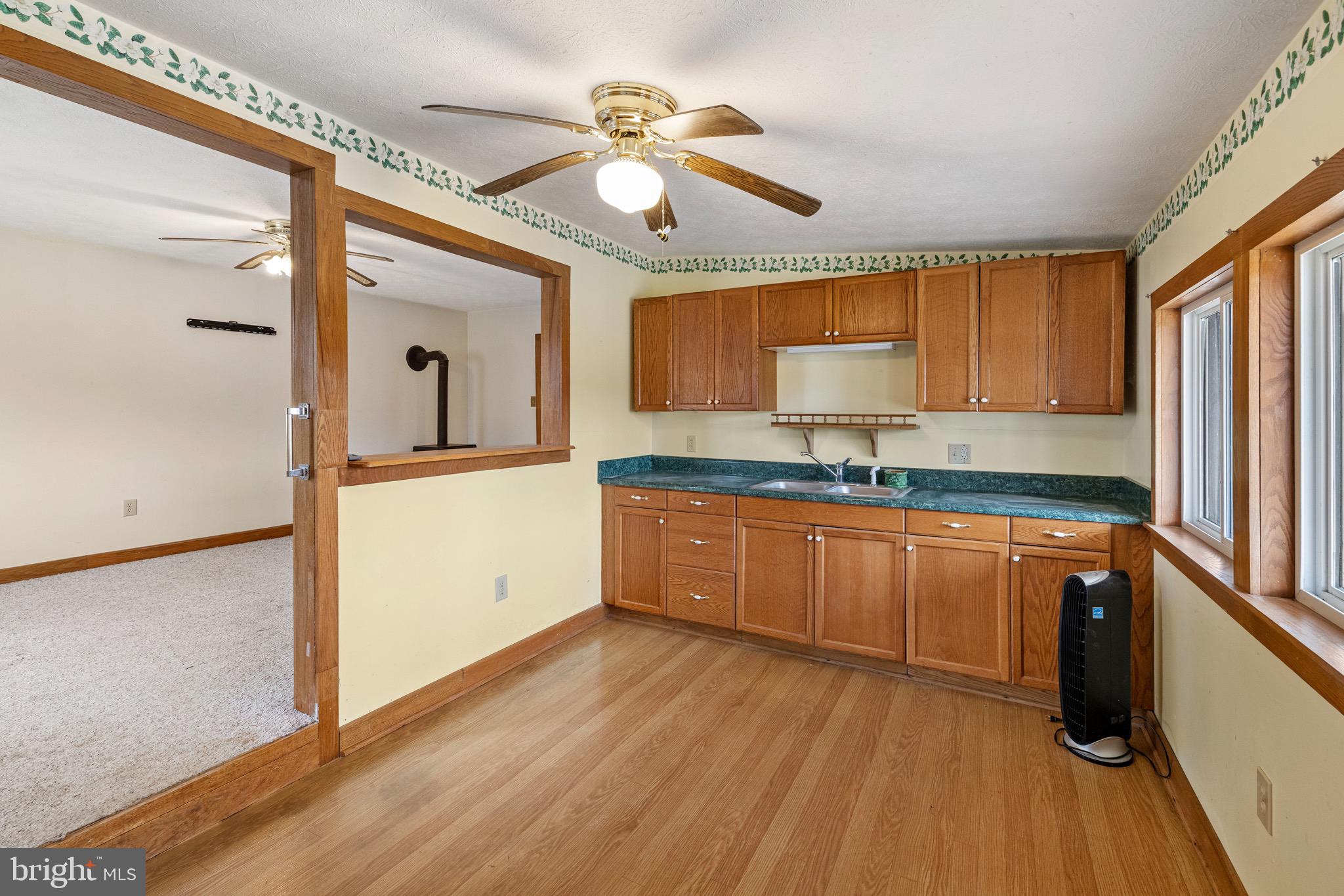 3360 Senedo Road Quicksburg, VA 22847 - Photo 37 of 58 a kitchen with stainless steel appliances granite countertop a sink cabinets and wooden floor