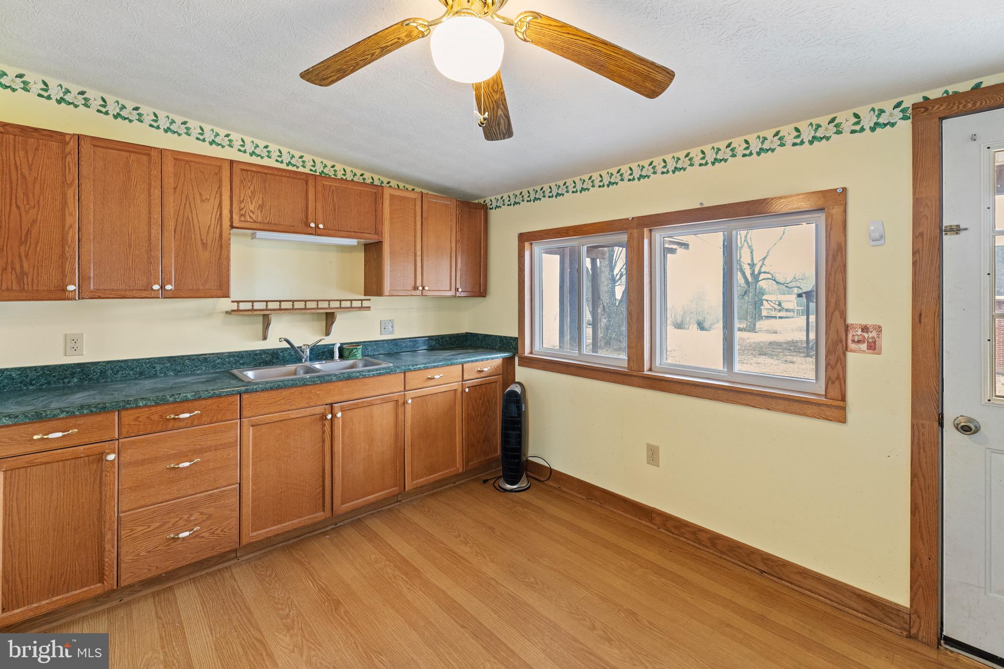 3360 Senedo Road Quicksburg, VA 22847 - Photo 38 of 58 a kitchen with granite countertop cabinets stainless steel appliances a sink and a window