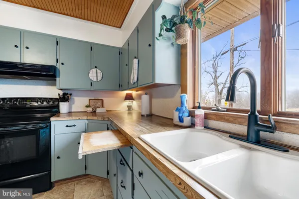 a kitchen with a stove a sink and a refrigerator