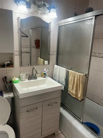 a bathroom with a sink a mirror a toilet and vanity