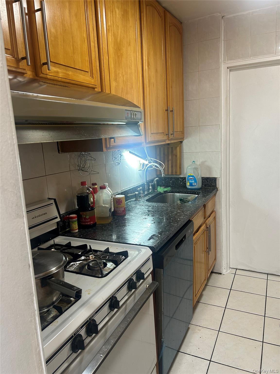 137-05 Franklin Avenue, Unit 3A Queens, NY 11355 - Photo 6 of 6 a kitchen with granite countertop a stove and a sink