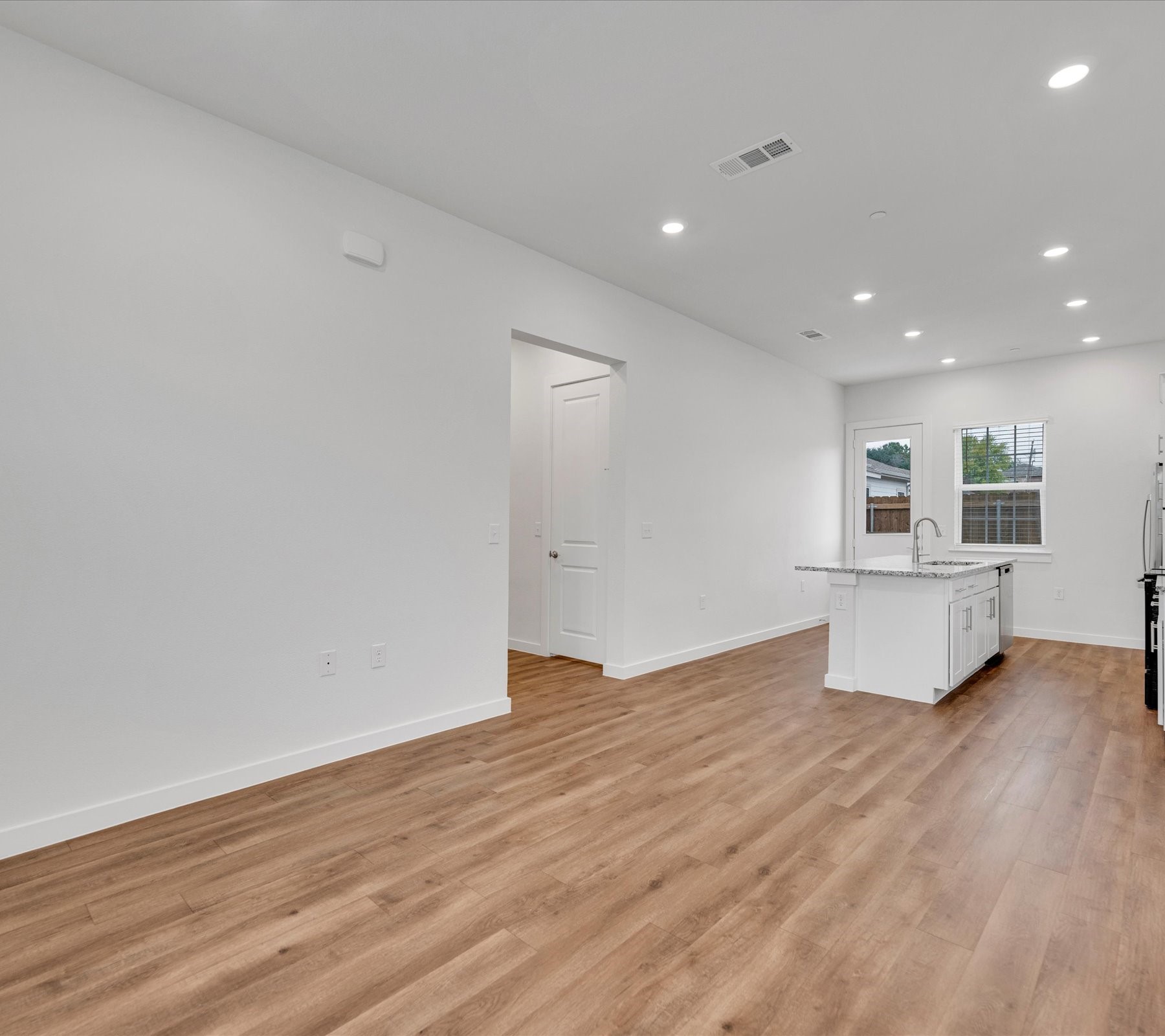 2703-403 Rockhill Road McKinney, TX 75072 - Photo 6 of 18 a view of kitchen and hall with wooden floor