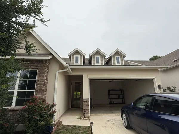 a front view of a house with parking space