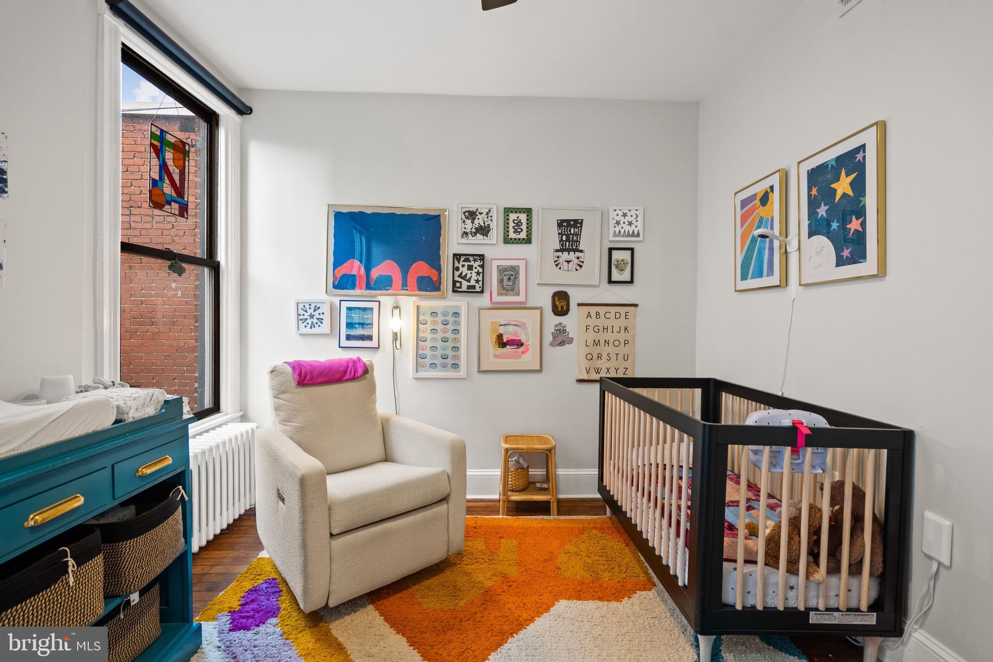 2026 15th Street Northwest Washington, DC 20009 - Photo 28 of 47 a living room with furniture a baby crib and a couch