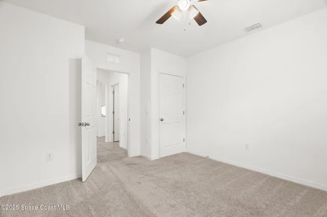 an empty room with a empty space and a ceiling fan