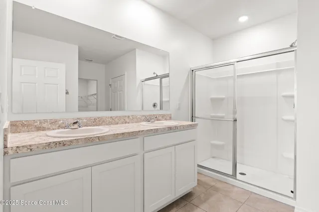 a bathroom with a granite countertop sink mirror and double