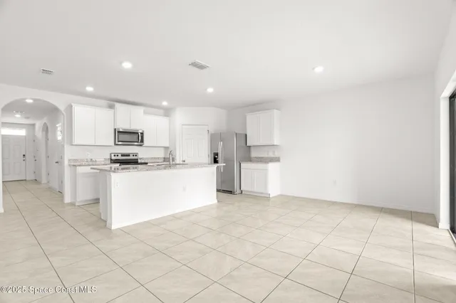 a kitchen with stainless steel appliances a refrigerator sink and cabinets