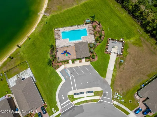 an aerial view of a house with a swimming pool