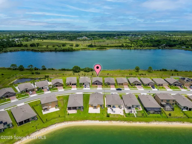 an aerial view of a house with outdoor space swimming pool and lake view