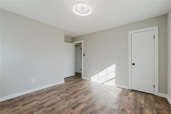 a view of an empty room and wooden floor
