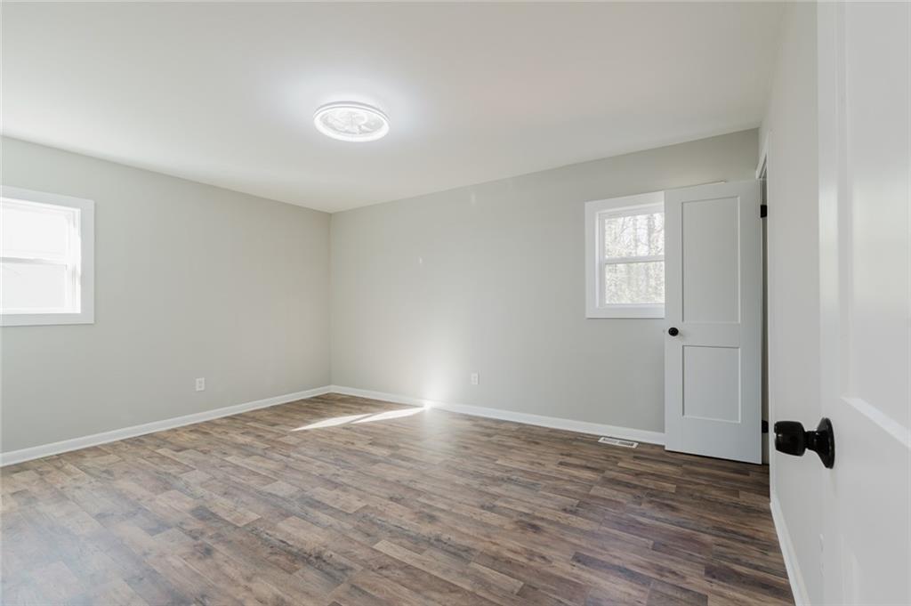 2976 Bay Berry Drive Southwest Marietta, GA 30008 - Photo 14 of 33 a view of an empty room with wooden floor and a window