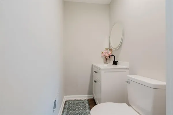 a bathroom with a sink and mirror with toilet