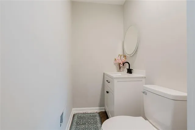 a bathroom with a sink and mirror with toilet