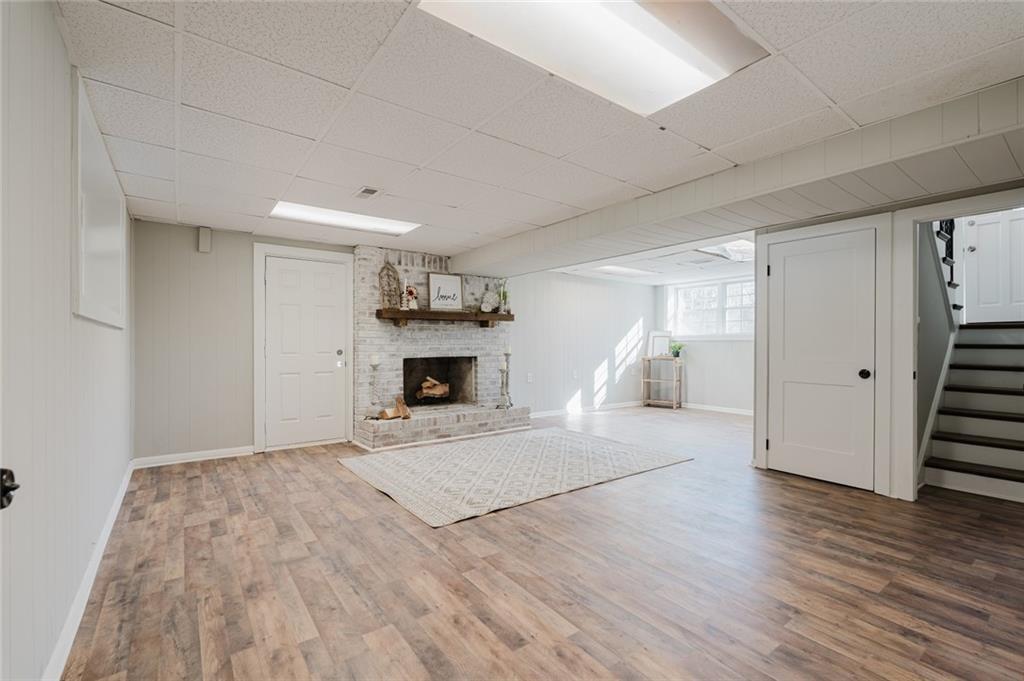 2976 Bay Berry Drive Southwest Marietta, GA 30008 - Photo 18 of 33 a view of empty room with wooden floor and fireplace