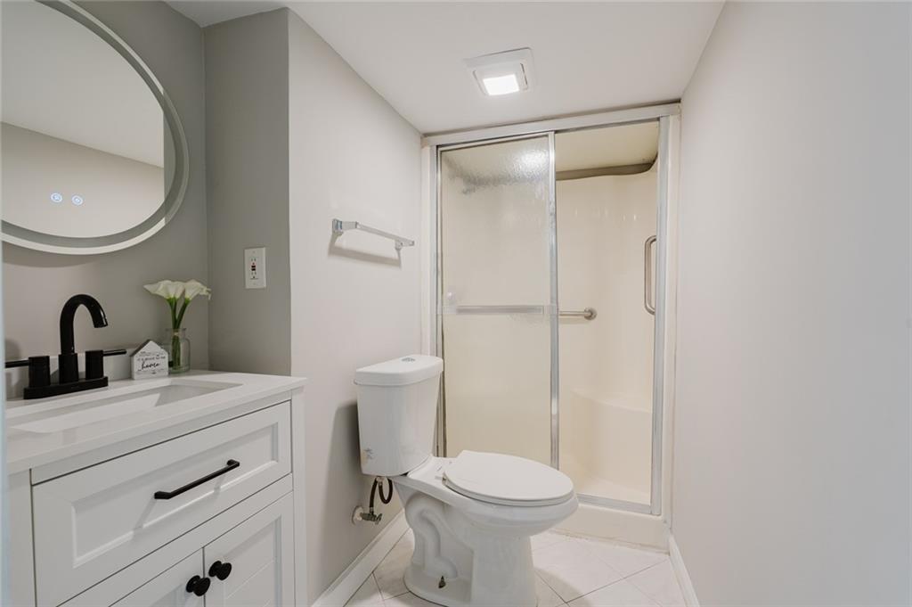 2976 Bay Berry Drive Southwest Marietta, GA 30008 - Photo 20 of 33 a bathroom with a sink a toilet and a mirror