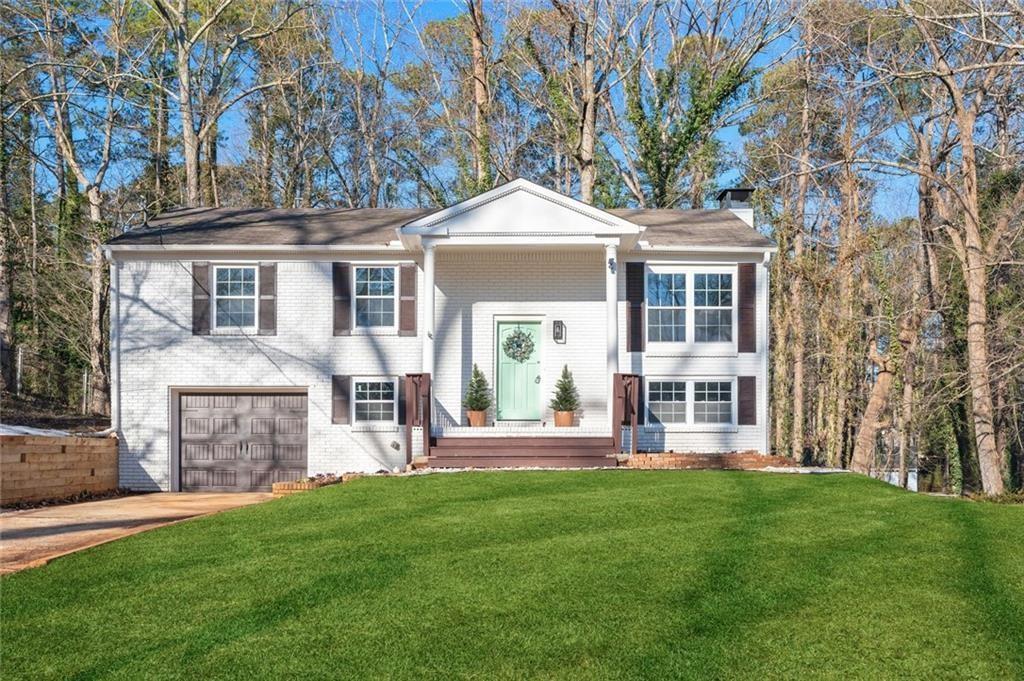 2976 Bay Berry Drive Southwest Marietta, GA 30008 - Photo 2 of 33 a front view of a house with a yard table and chairs
