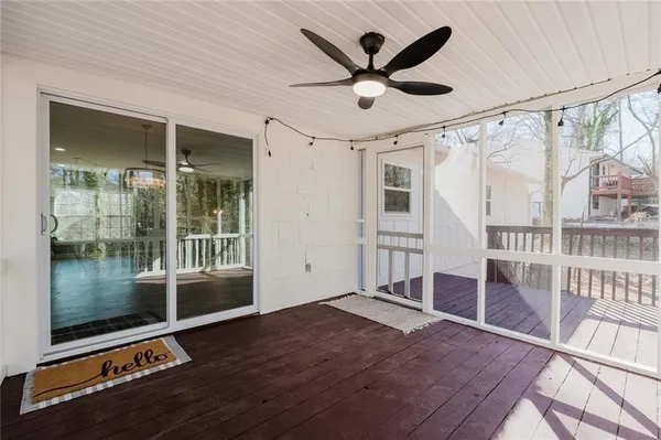 a view of a livingroom with wooden floor and a ceiling fan