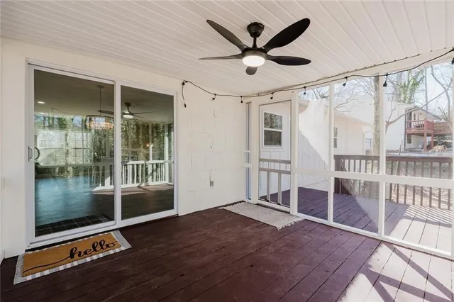 a view of a livingroom with wooden floor and a ceiling fan