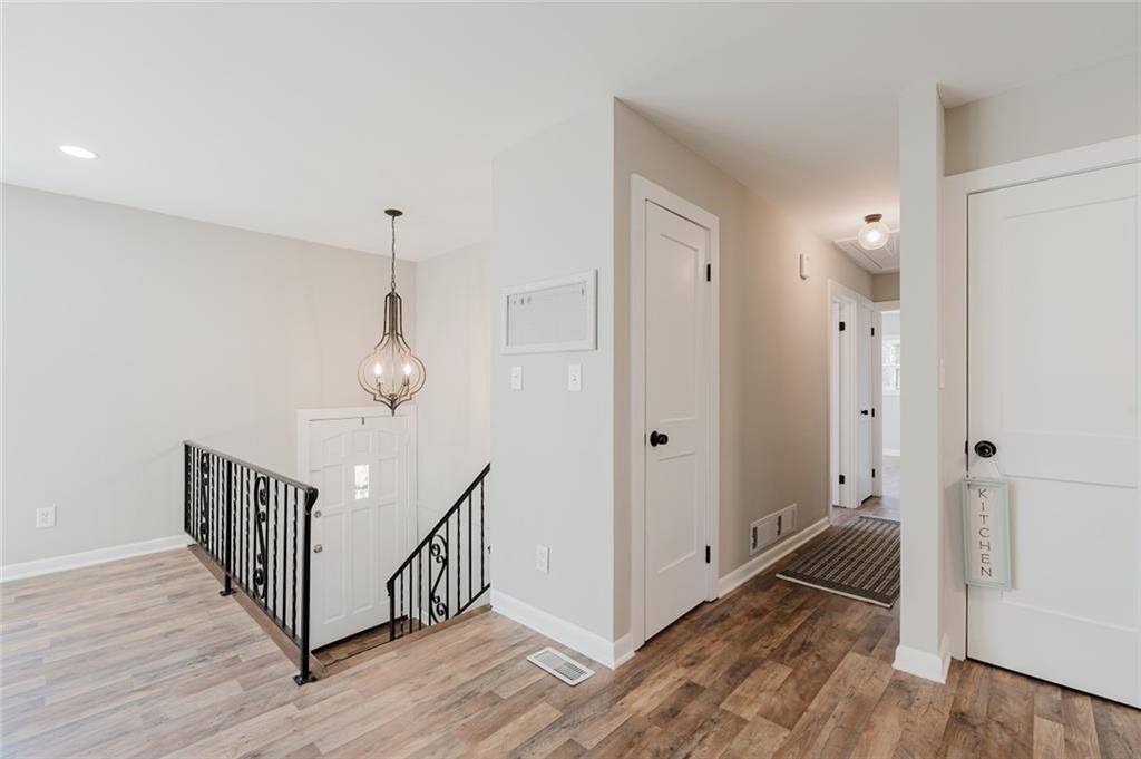 2976 Bay Berry Drive Southwest Marietta, GA 30008 - Photo 6 of 33 a view of a hallway with wooden floor and staircase