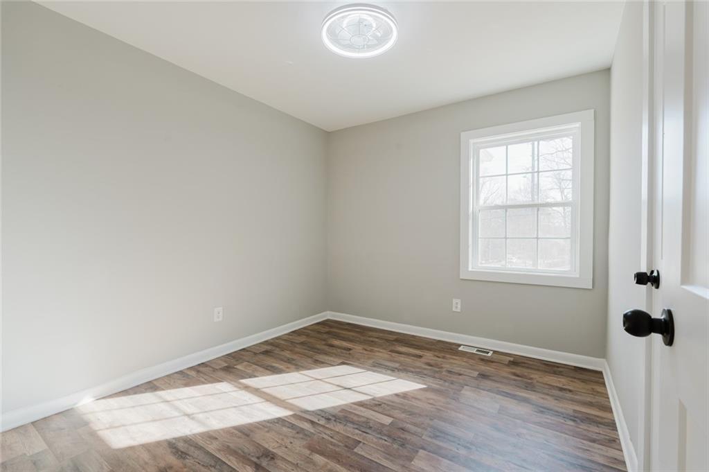 2976 Bay Berry Drive Southwest Marietta, GA 30008 - Photo 10 of 33 an empty room with wooden floor and windows