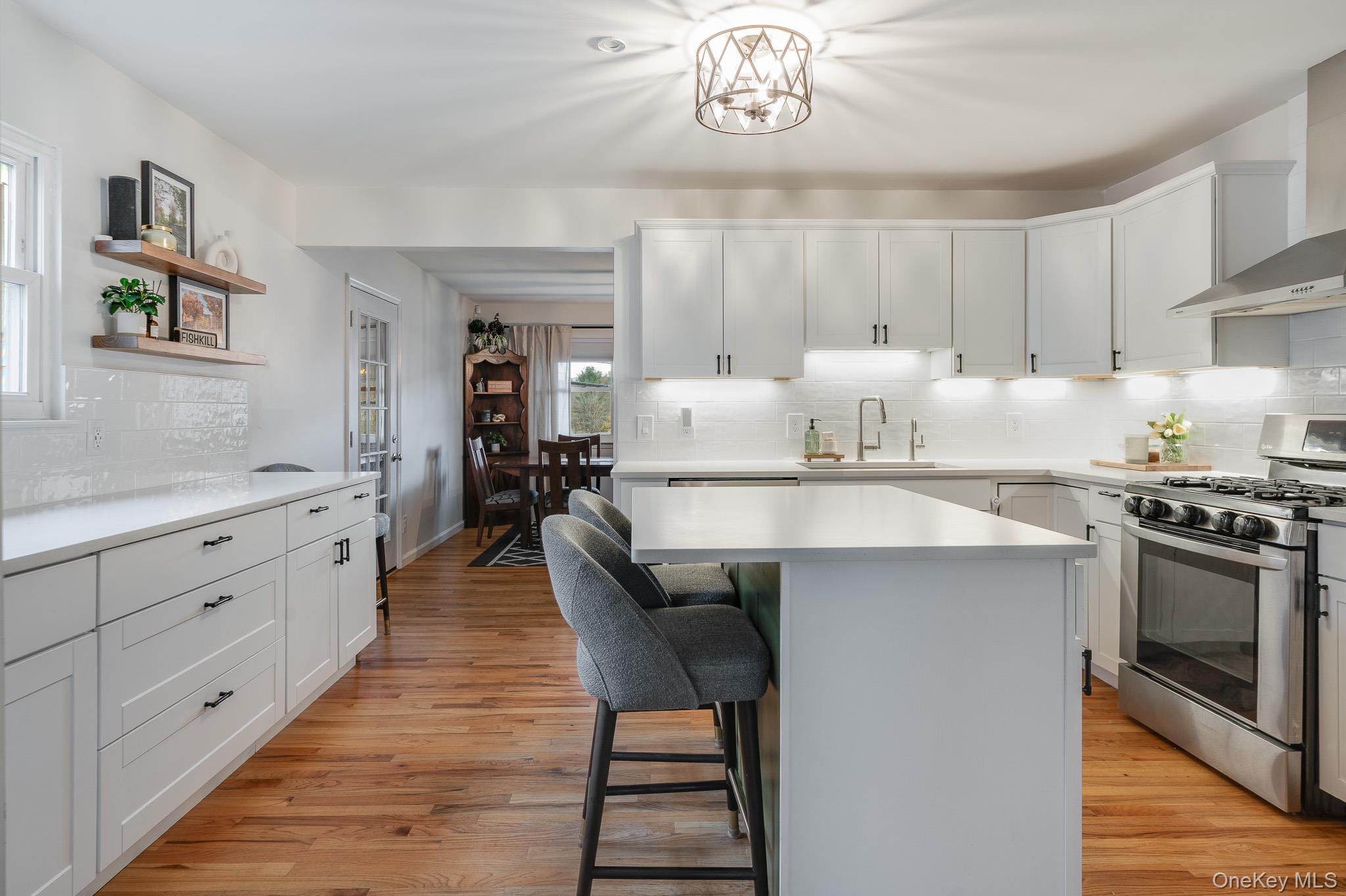 29 Wedgewood Road Fishkill, NY 12524 - Photo 4 of 19 a kitchen with a table chairs stove and cabinets