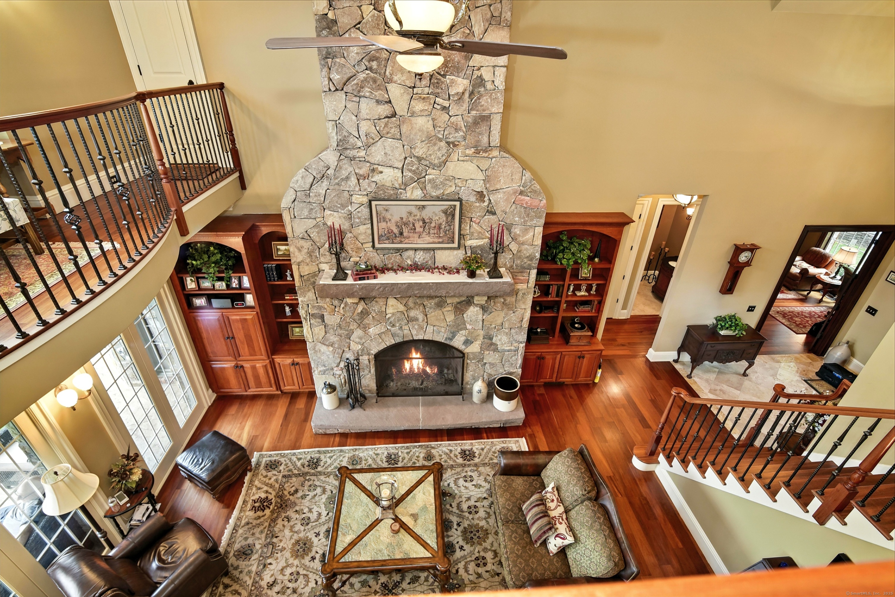 282 Searles Road Pomfret, CT 06259 - Photo 23 of 40 Twenty-foot ceiling, bowed interior balcony, and full-height Tennessee fieldstone fireplace characterize the Great Room.