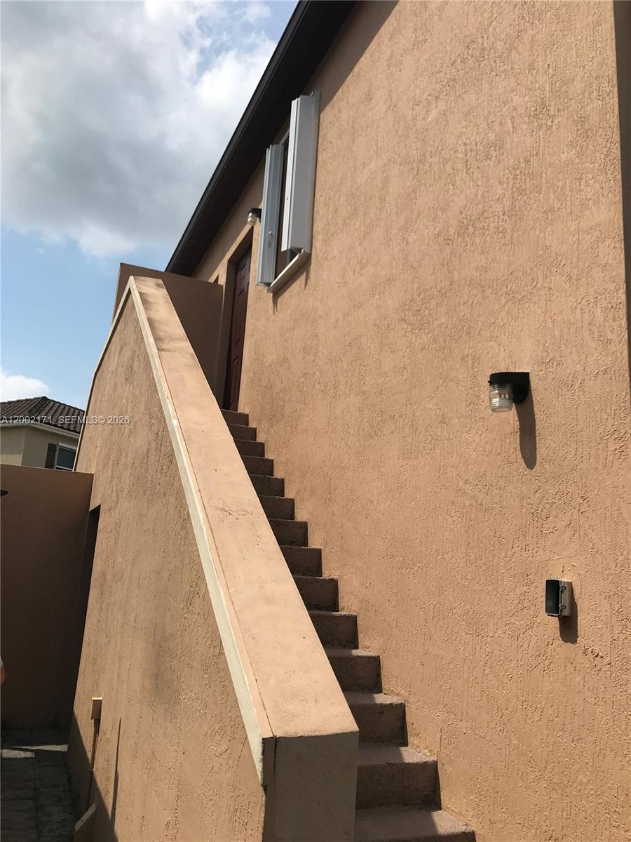 9515 Southwest 171st Place, Unit ANNEX Miami, FL 33196 - Photo 2 of 26 a view of balcony with wooden floor and stairs