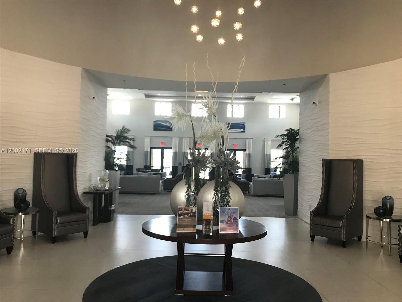 9515 Southwest 171st Place, Unit ANNEX Miami, FL 33196 - Photo 23 of 26 a room with lots of tables a chandelier and couches chair