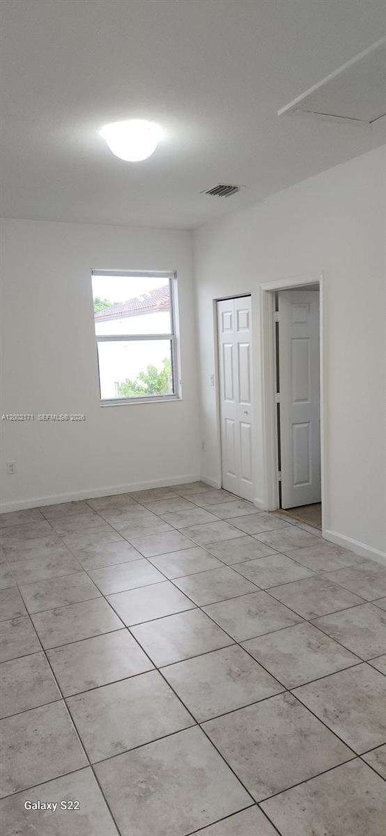 9515 Southwest 171st Place, Unit ANNEX Miami, FL 33196 - Photo 3 of 26 an empty room with a empty space and windows