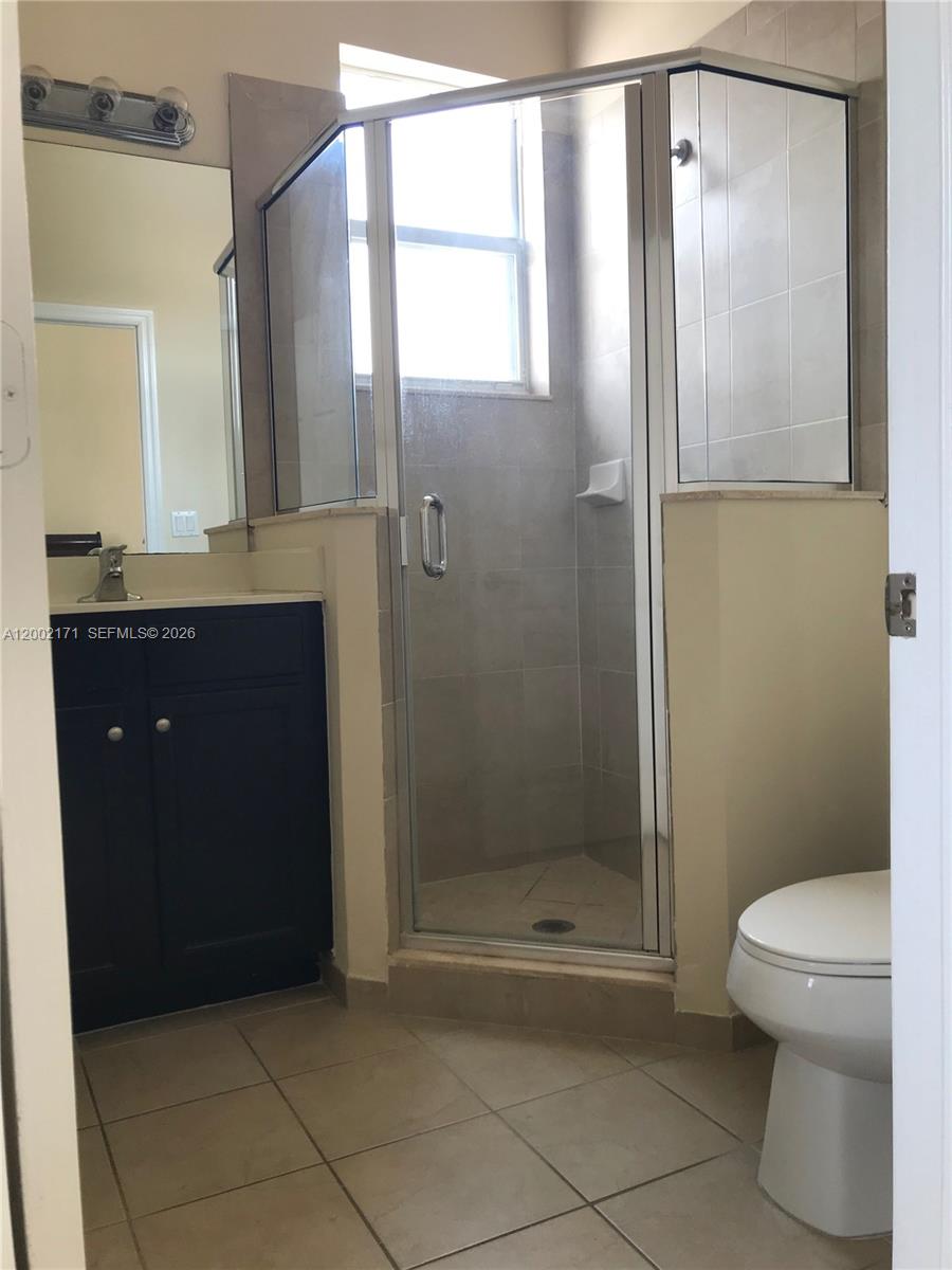 9515 Southwest 171st Place, Unit ANNEX Miami, FL 33196 - Photo 8 of 26 a bathroom with a glass shower door
