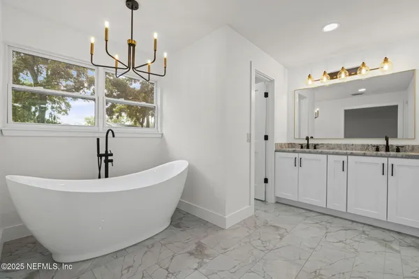 a white bath tub sitting in a bathroom