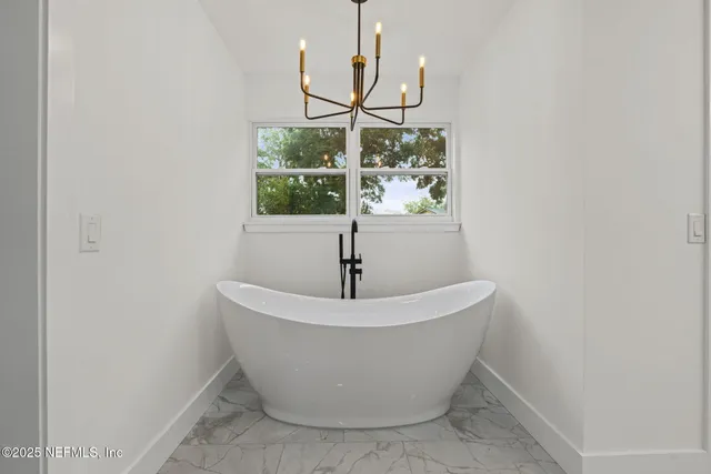 a white bath tub sitting in a bathroom