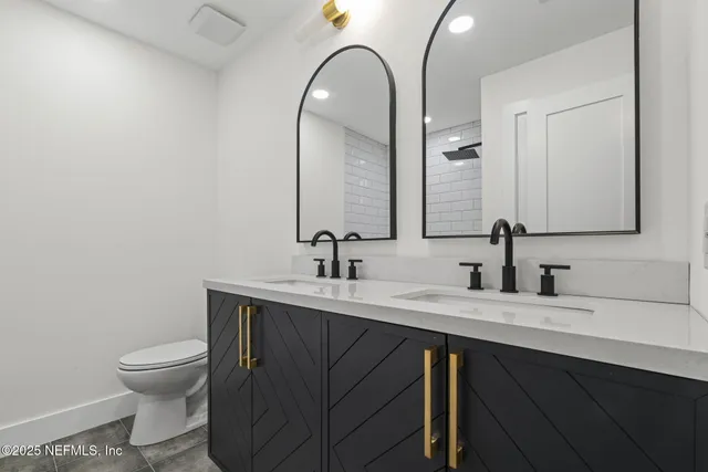 a bathroom with a toilet sink and mirror