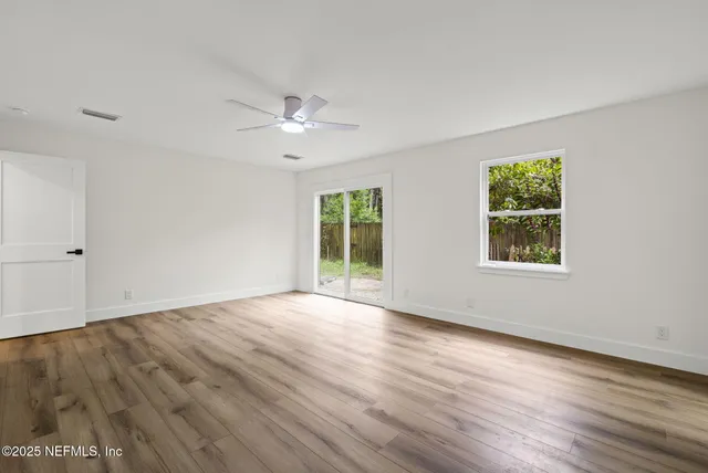 wooden floor in an empty room with a window