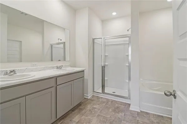 a bathroom with a double vanity sink mirror and shower