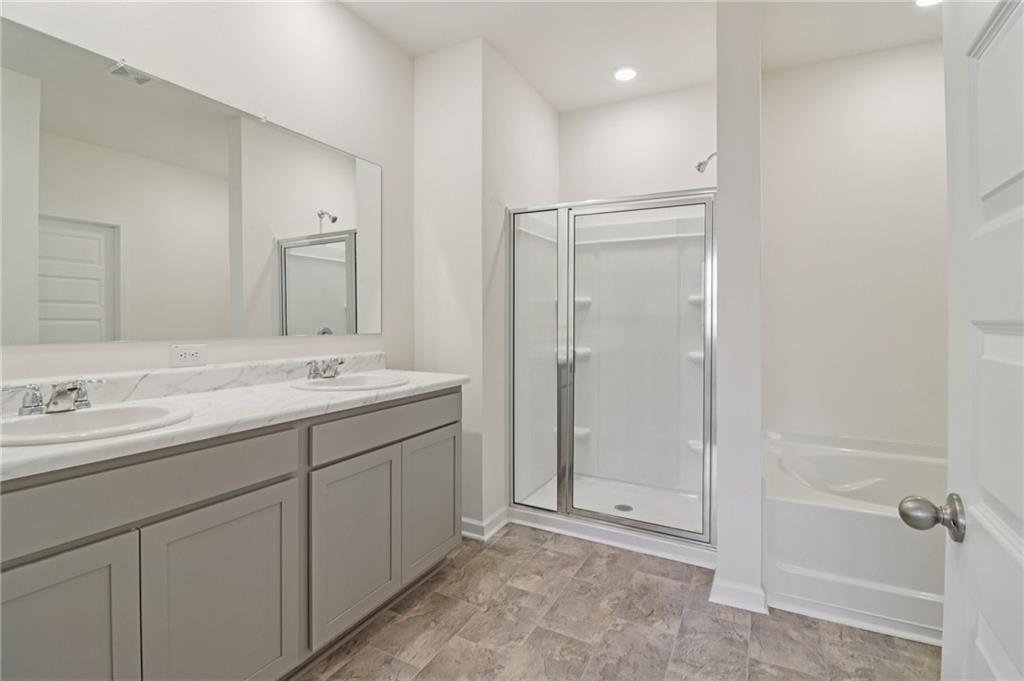 1729 Limousin Way Stockbridge, GA 30281 - Photo 13 of 26 a bathroom with a double vanity sink mirror and shower