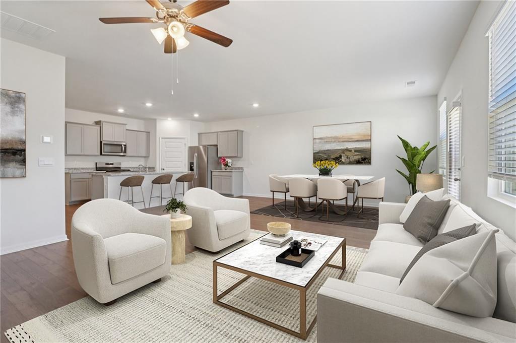 1729 Limousin Way Stockbridge, GA 30281 - Photo 2 of 26 a living room with furniture kitchen view and a chandelier