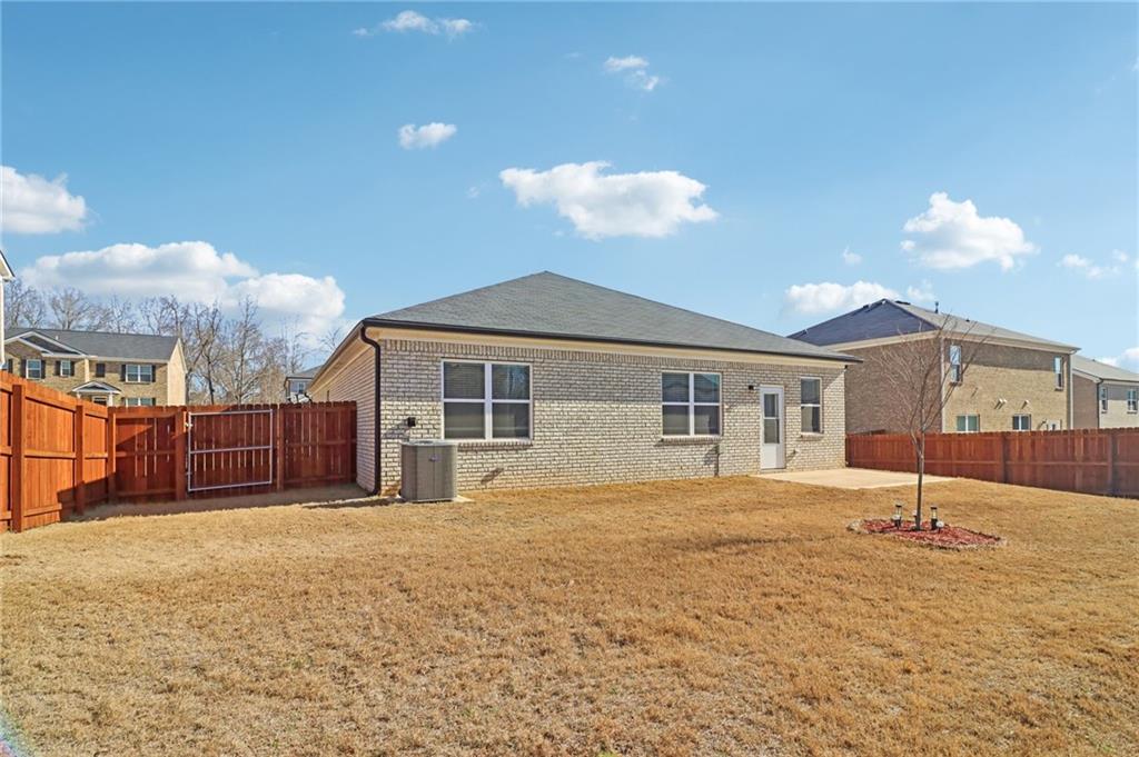 1729 Limousin Way Stockbridge, GA 30281 - Photo 22 of 26 a front view of a house with a yard and garage
