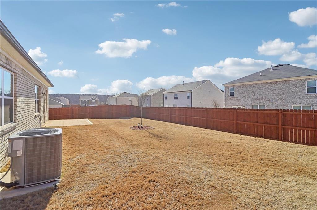 1729 Limousin Way Stockbridge, GA 30281 - Photo 23 of 26 a kitchen with kitchen island granite countertop a stove and a sink