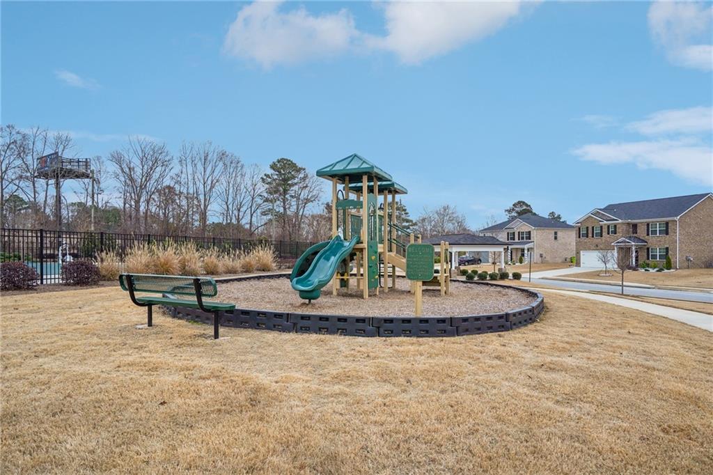 1729 Limousin Way Stockbridge, GA 30281 - Photo 26 of 26 a swimming pool with outdoor seating and barbeque oven