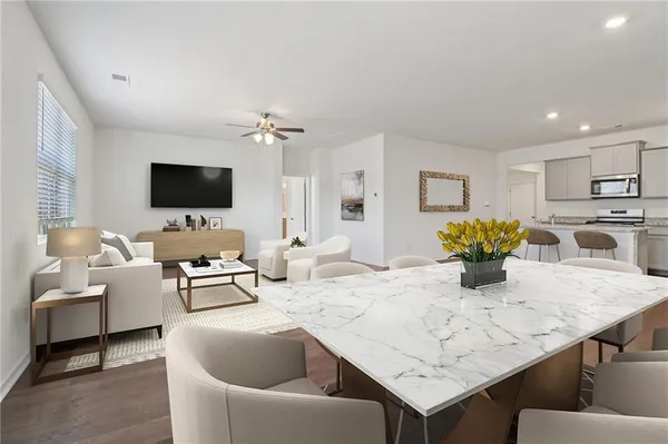 a living room with furniture and a kitchen view
