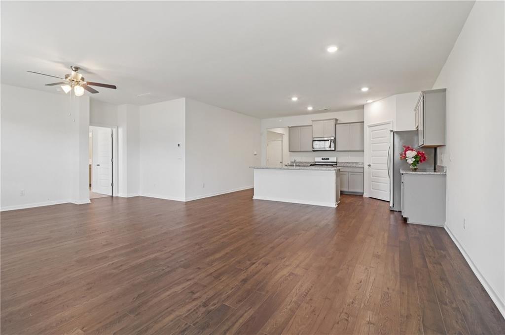 1729 Limousin Way Stockbridge, GA 30281 - Photo 7 of 26 a view of a kitchen with wooden floor and a refrigerator