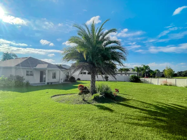 a view of a big house with a big yard