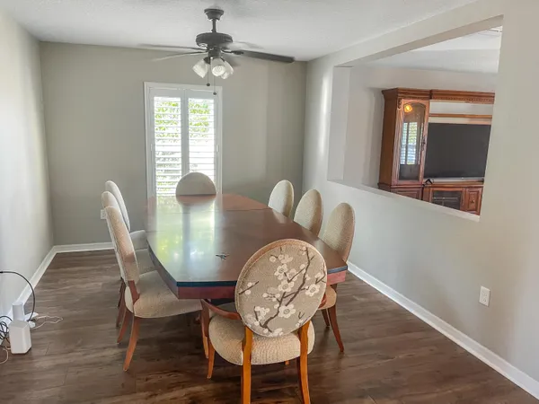 a view of a dining room with furniture window and wooden floor