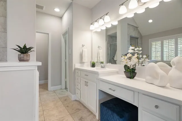 a bathroom with a sink a vanity and a mirror