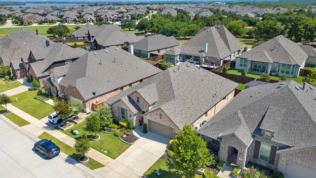an aerial view of a house with yard and mountain view in back