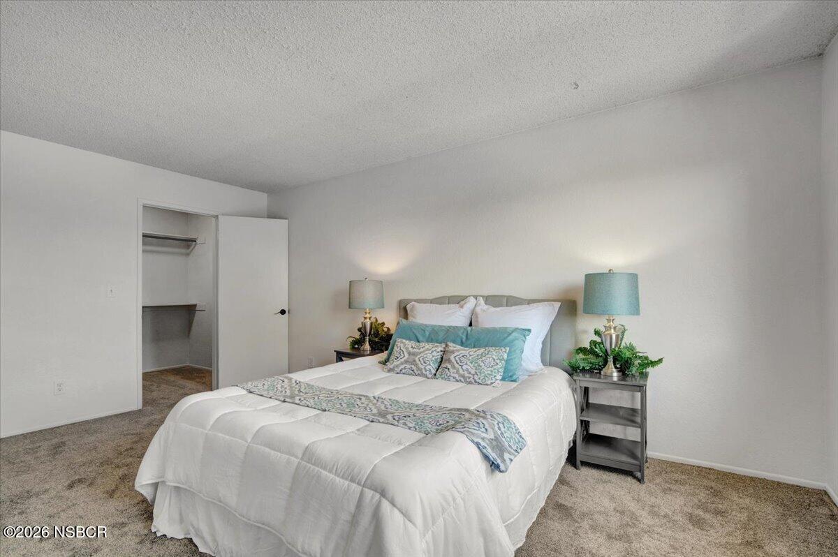 3400 Santa Maria Way, Unit 207B Santa Maria, CA 93455 - Photo 30 of 50 a bedroom with a bed and a potted plant