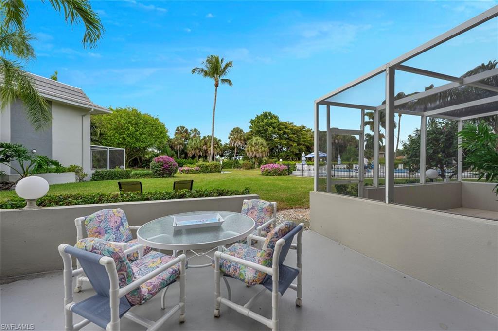 215 Cypress Way East, Unit C4 Naples, FL 34110 - Photo 13 of 15 a view of outdoor space yard swimming pool and patio