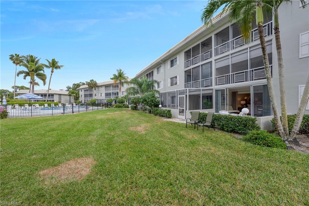 215 Cypress Way East, Unit C4 Naples, FL 34110 - Photo 14 of 15 a front view of house with a garden